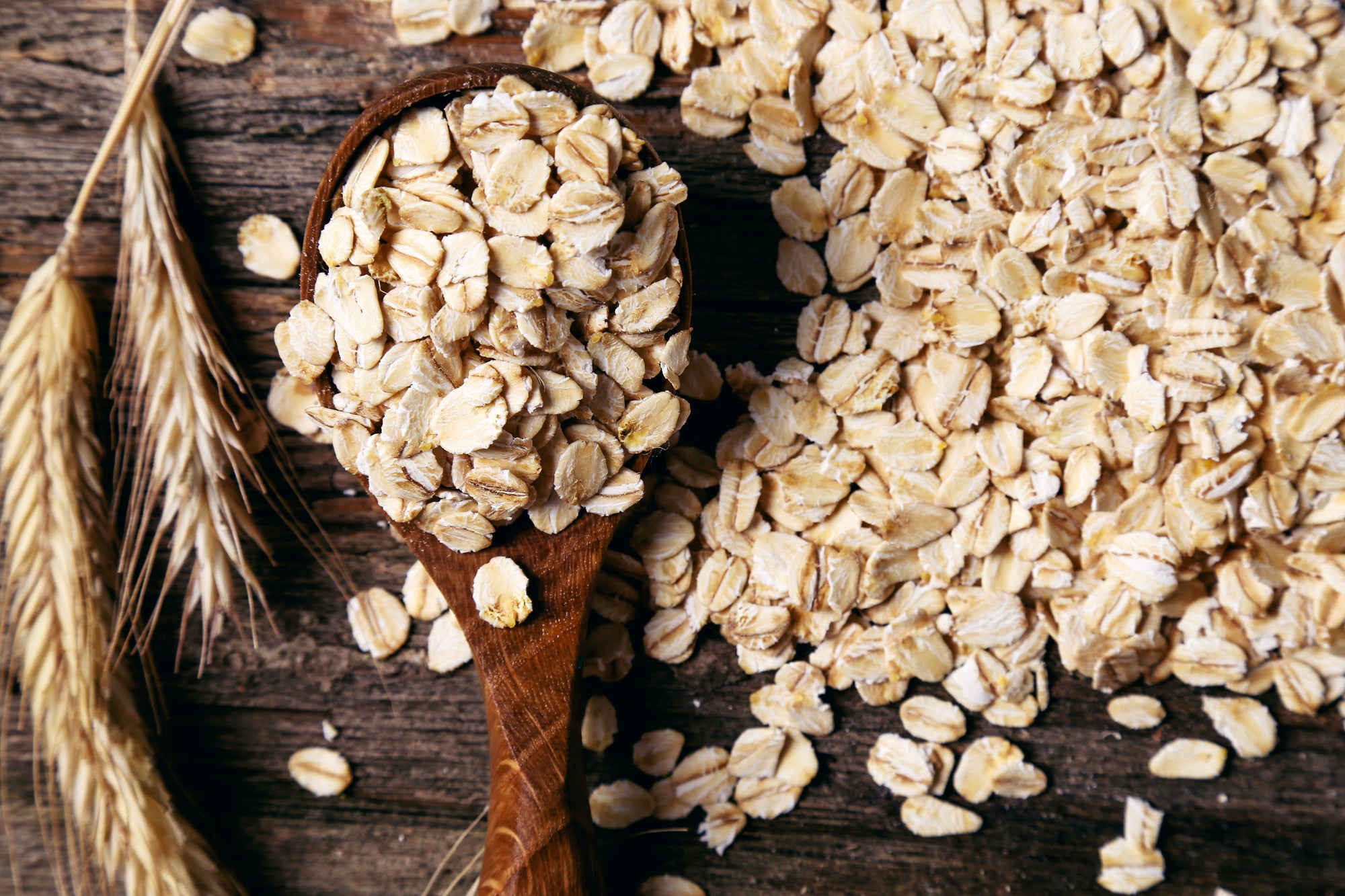 DIY oat milk represented by a spoonful of oat grains