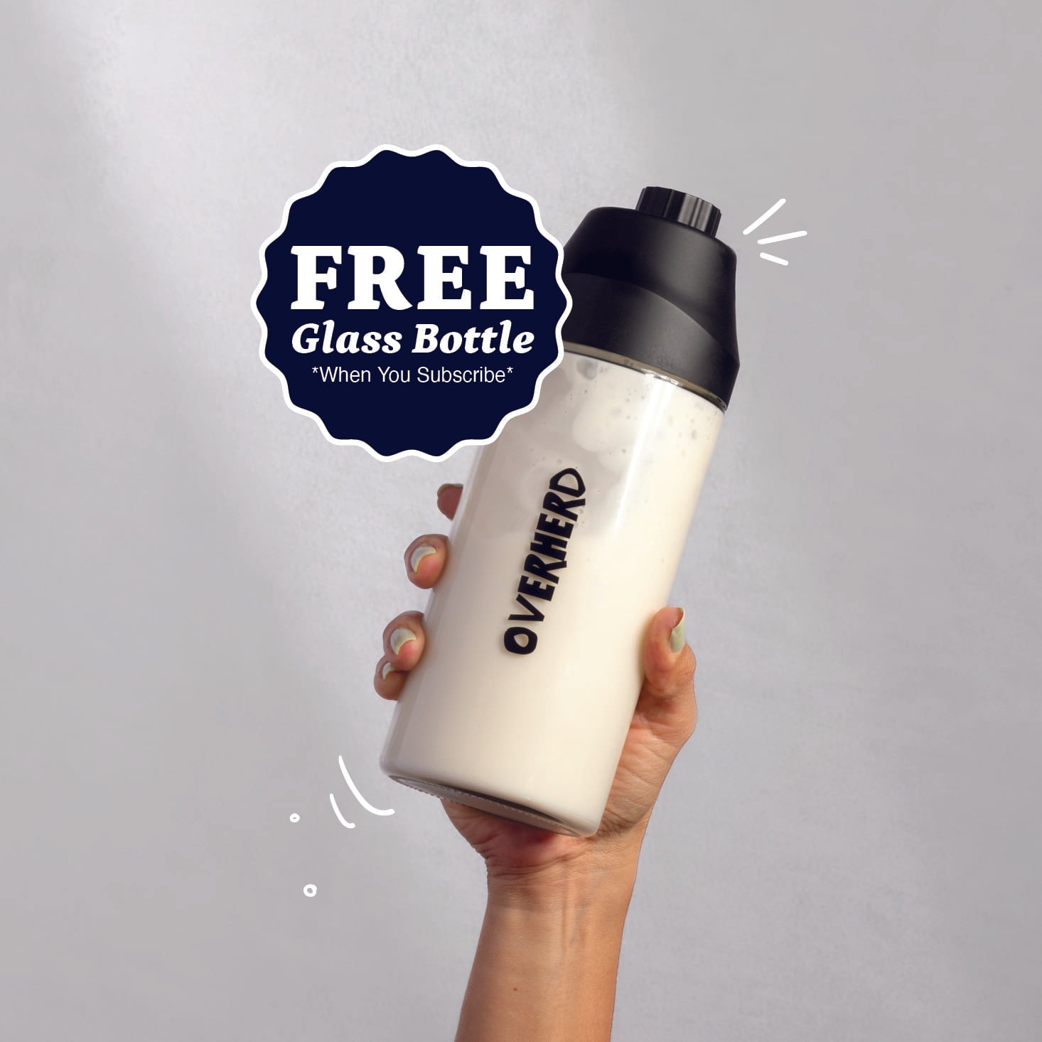 Hand holding bottle of Overherd oat milk
