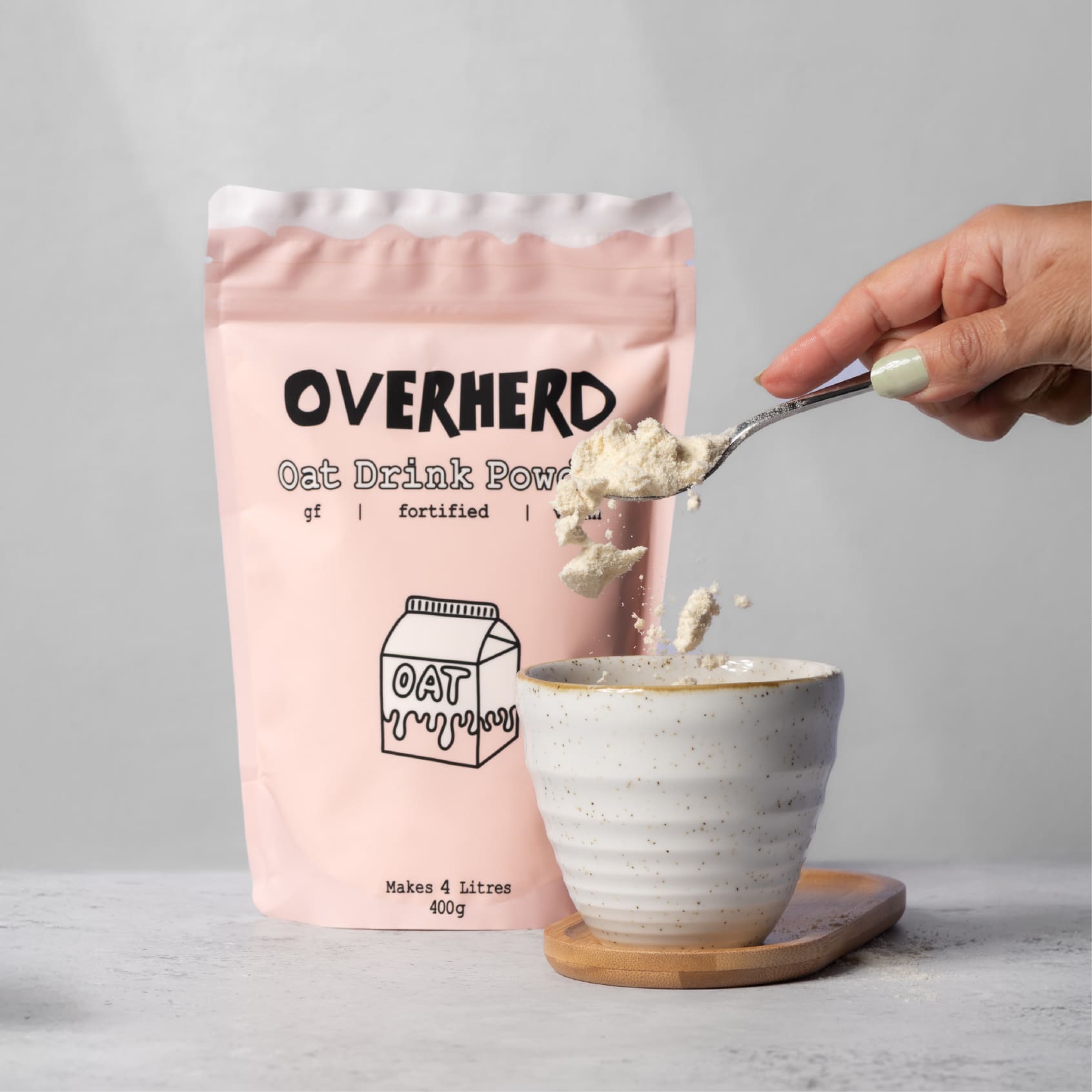Spooning Overherd oat milk powder straight into coffee