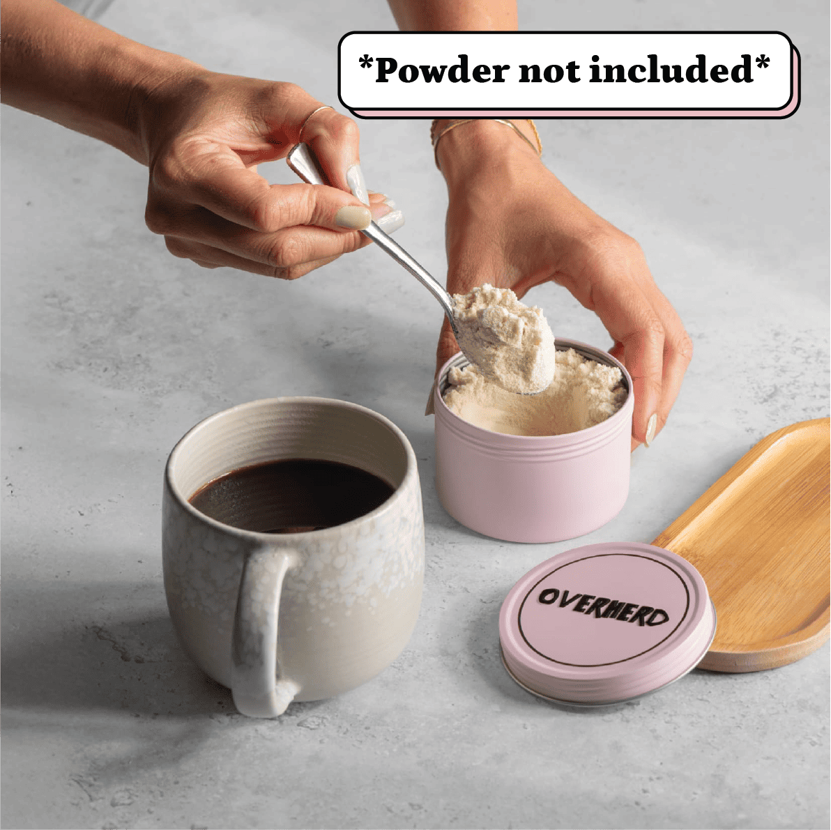 Scooping oat milk powder out of travel tin into a coffee