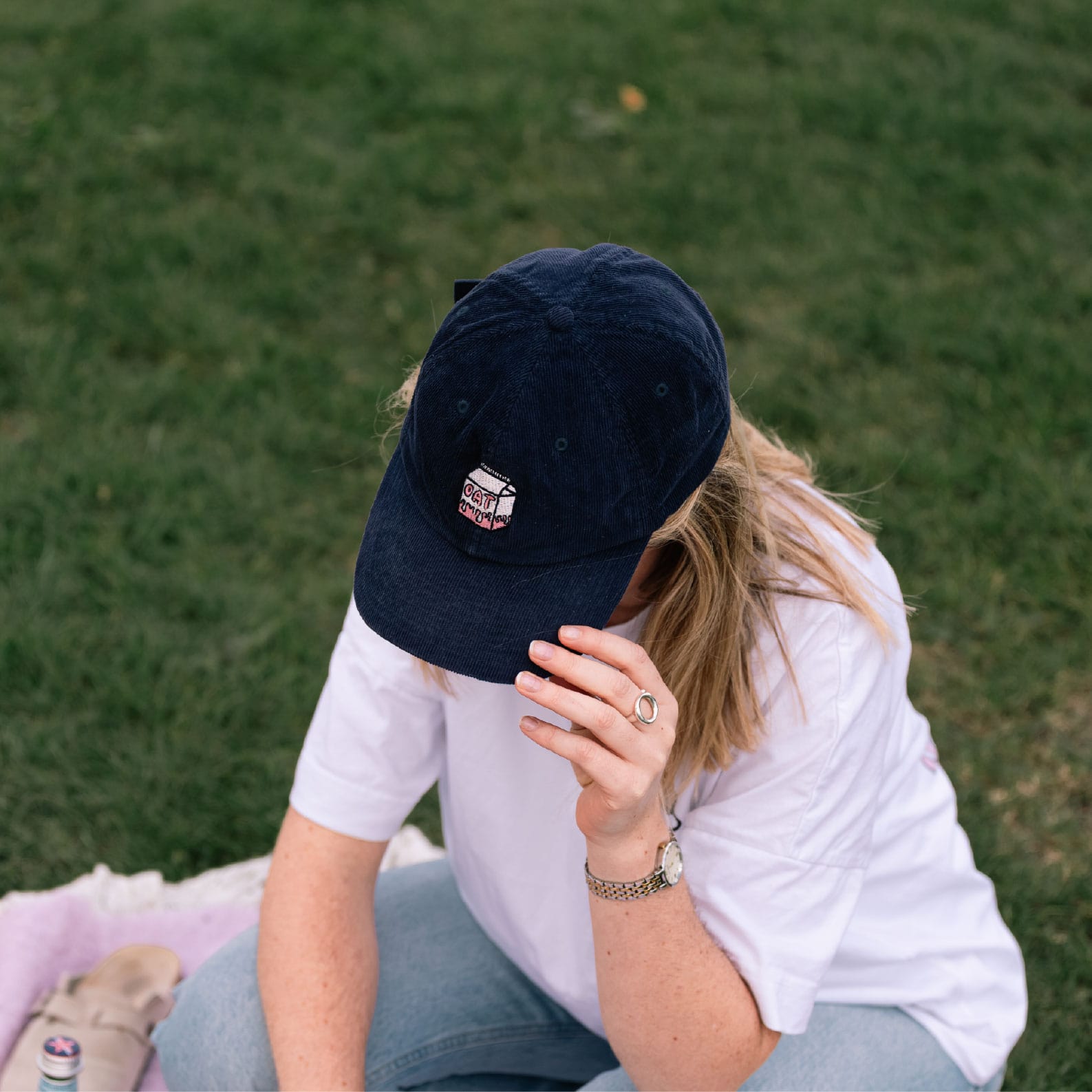 Navy oat milk corduroy cap on a girl