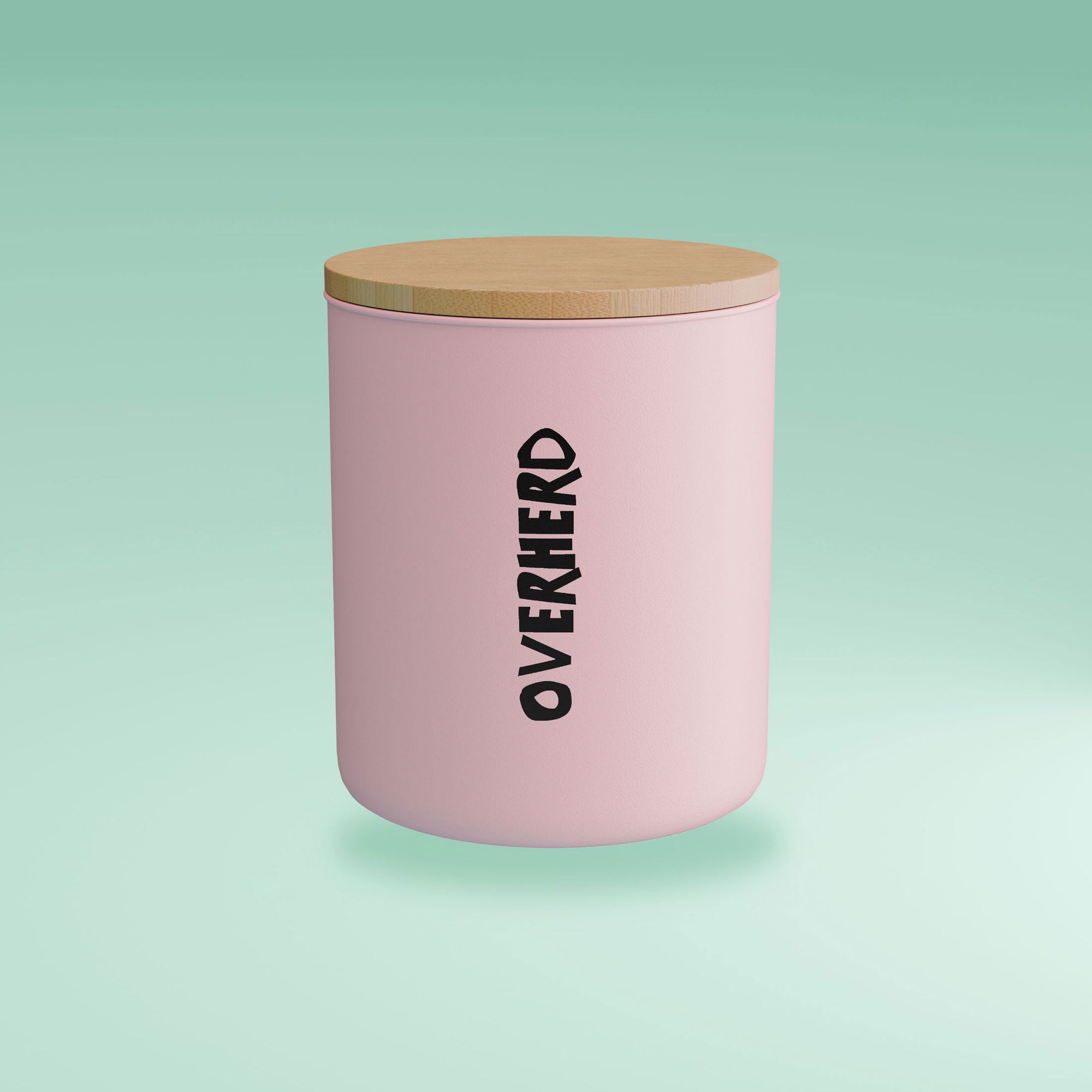 Overherd pink storage tin with bamboo lid on green gradient background