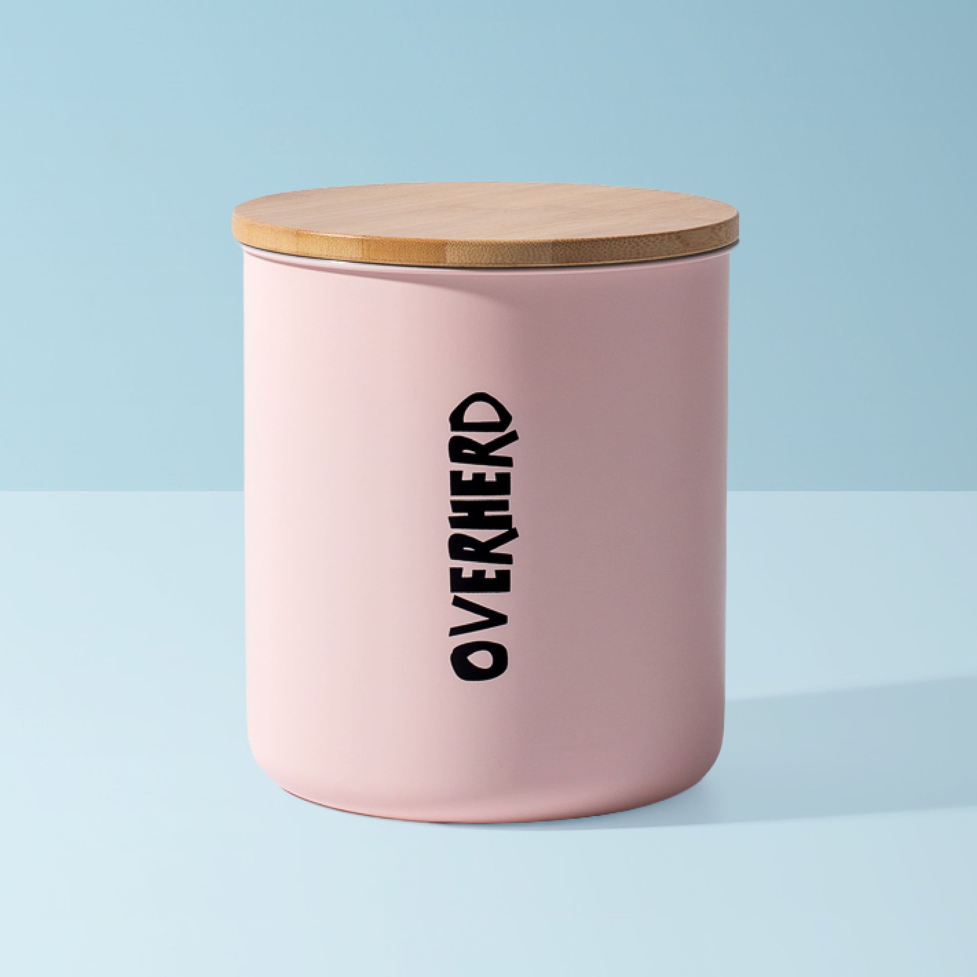 Pink Overherd storage tin on blue background