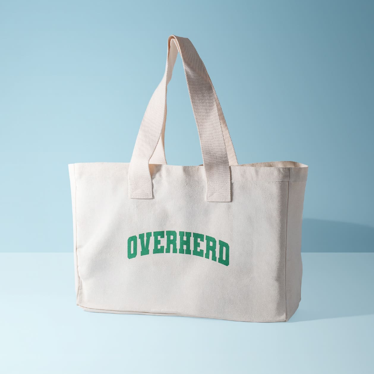 Overherd tote bag on blue background