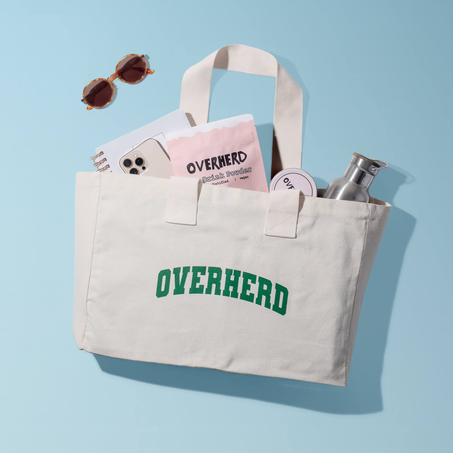 Overherd tote bag with accessories spilling out